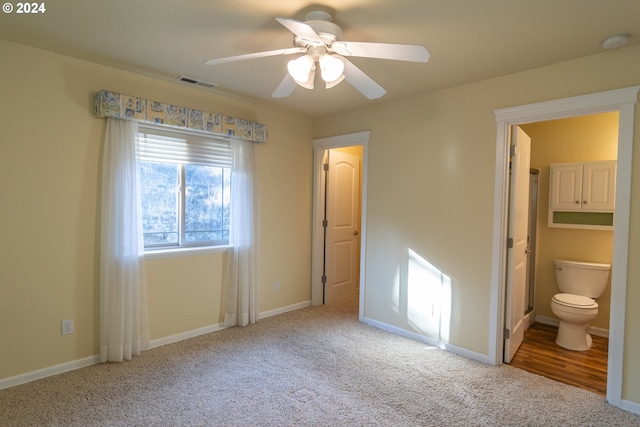 unfurnished bedroom with connected bathroom, carpet floors, and ceiling fan