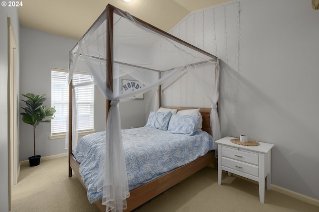 carpeted bedroom with lofted ceiling