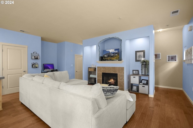 living room with hardwood / wood-style flooring and a fireplace