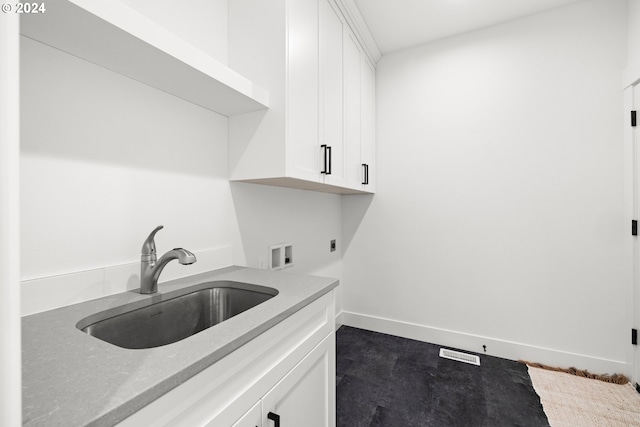 clothes washing area featuring sink, electric dryer hookup, cabinets, and hookup for a washing machine