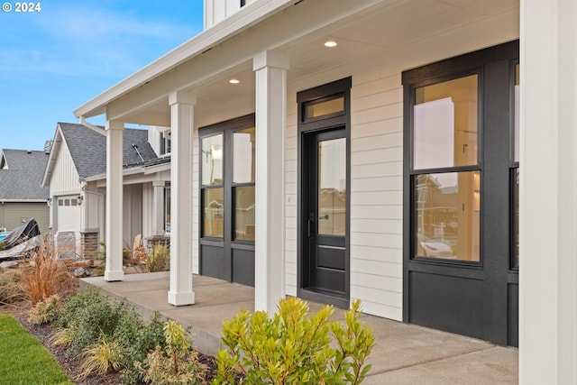 view of exterior entry with a porch