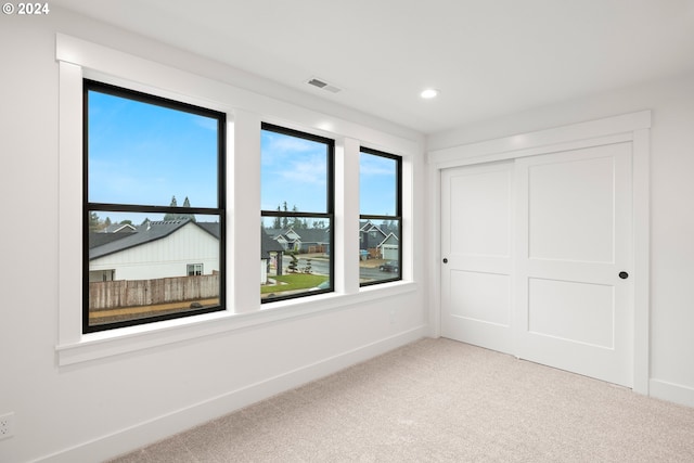 unfurnished bedroom featuring a closet and carpet flooring