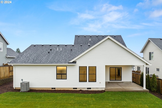 rear view of property featuring a patio, cooling unit, and a yard