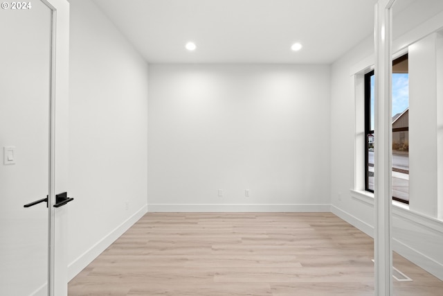 unfurnished room with light wood-type flooring and a wealth of natural light