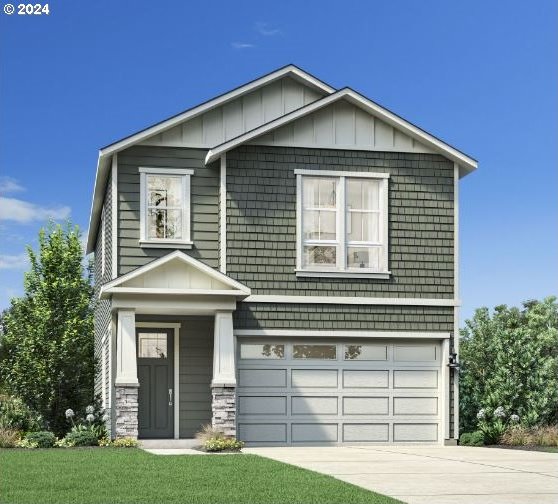 view of front of property with a front yard and a garage