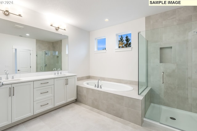 bathroom with vanity and separate shower and tub