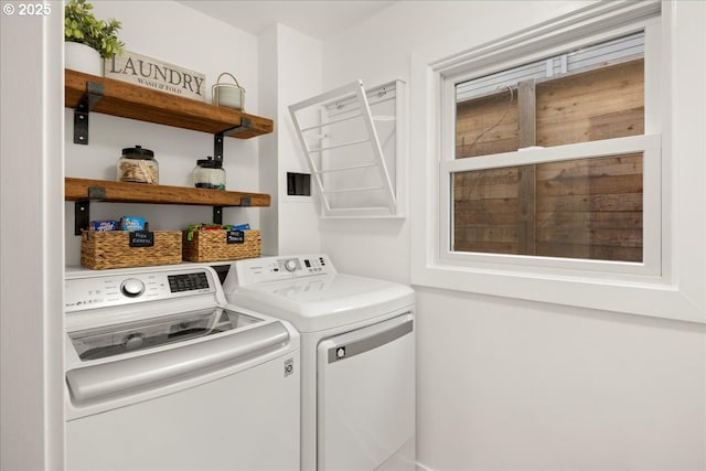 clothes washing area featuring laundry area and separate washer and dryer