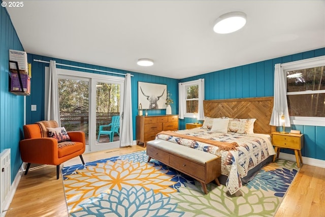 bedroom featuring access to exterior and light hardwood / wood-style floors