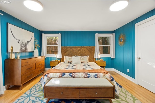 bedroom featuring wood finished floors and baseboards