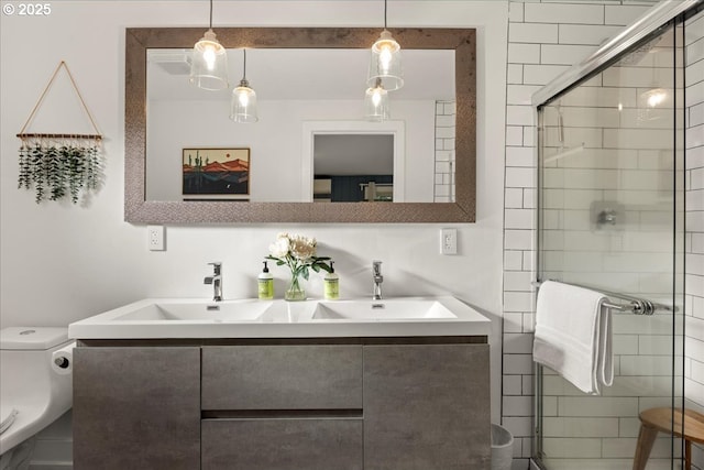 bathroom with an enclosed shower, vanity, and toilet