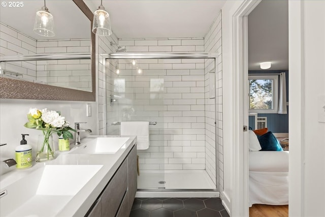 bathroom with a shower with door and vanity