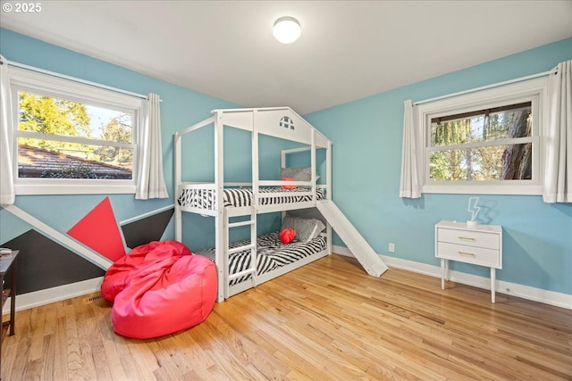 bedroom with wood finished floors and baseboards