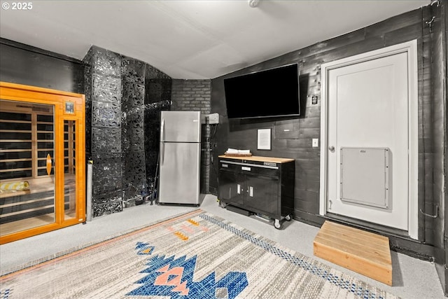 kitchen featuring freestanding refrigerator and vaulted ceiling