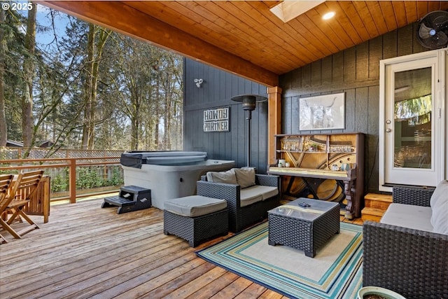 wooden terrace featuring outdoor lounge area and a hot tub