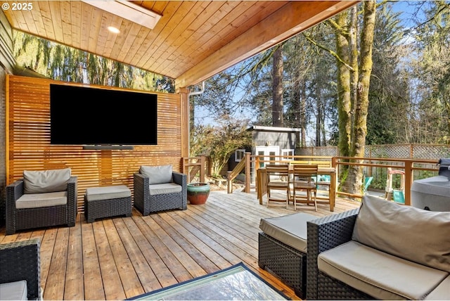 wooden deck with fence and an outdoor living space