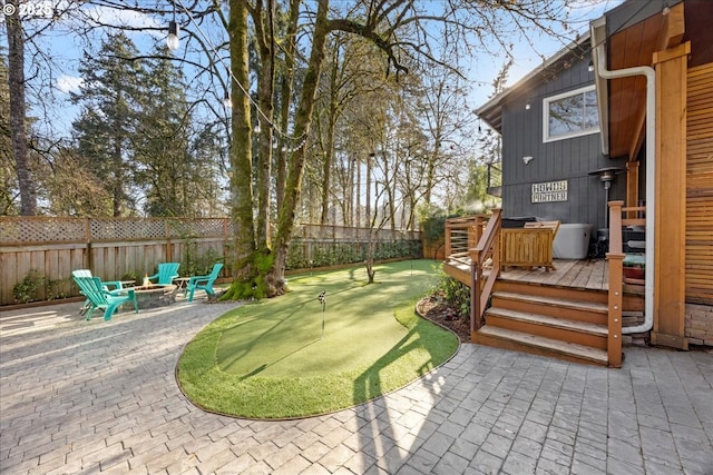 view of yard with a patio area, a deck, and an outdoor fire pit