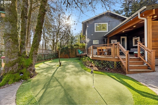 view of yard featuring fence and a deck