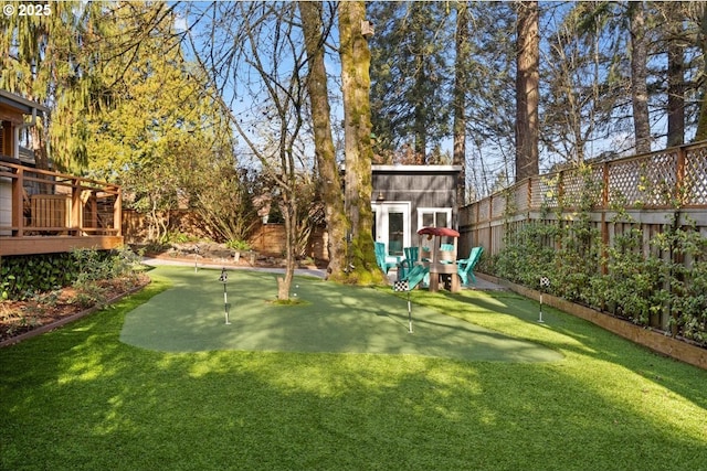 view of yard with a deck and a storage unit