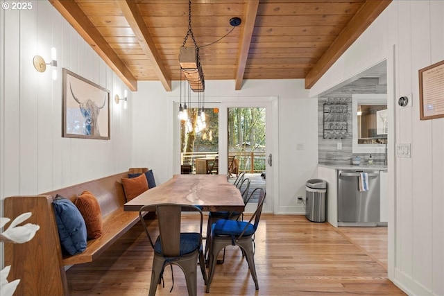 dining area with beam ceiling, breakfast area, an inviting chandelier, light wood-type flooring, and wooden ceiling