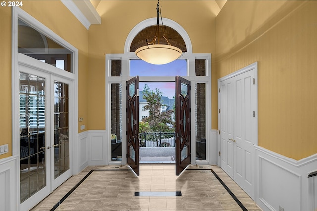 foyer with a high ceiling and french doors