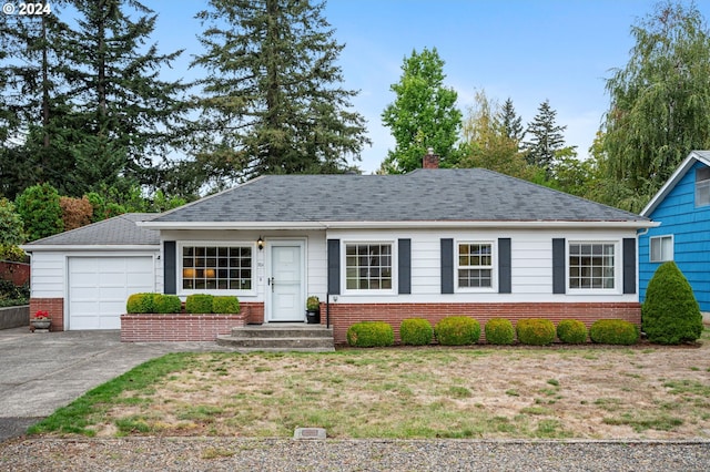 ranch-style home with a garage and a front lawn