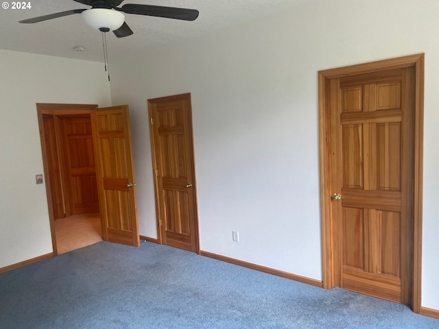 unfurnished bedroom with carpet floors, baseboards, and ceiling fan