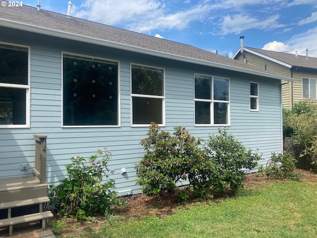 view of side of property with a shingled roof