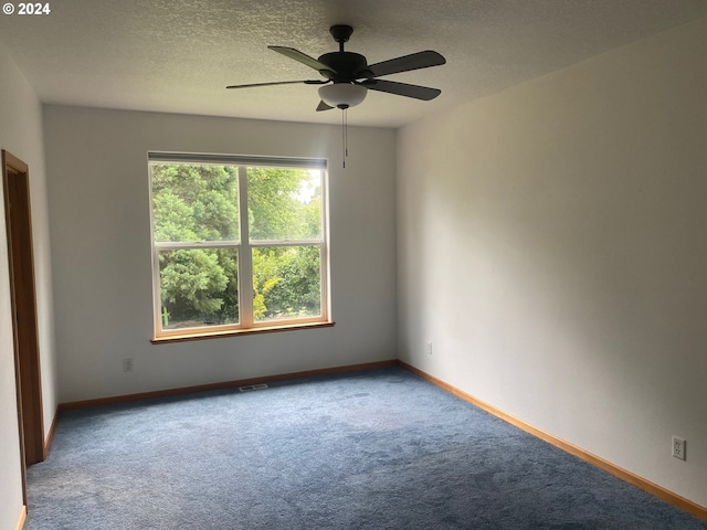empty room featuring baseboards, ceiling fan, carpet, and visible vents