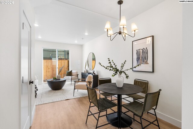 dining space featuring a chandelier and light hardwood / wood-style flooring