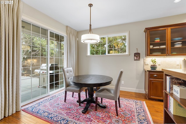 dining room with a healthy amount of sunlight and light wood-type flooring