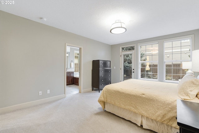 carpeted bedroom with ensuite bath