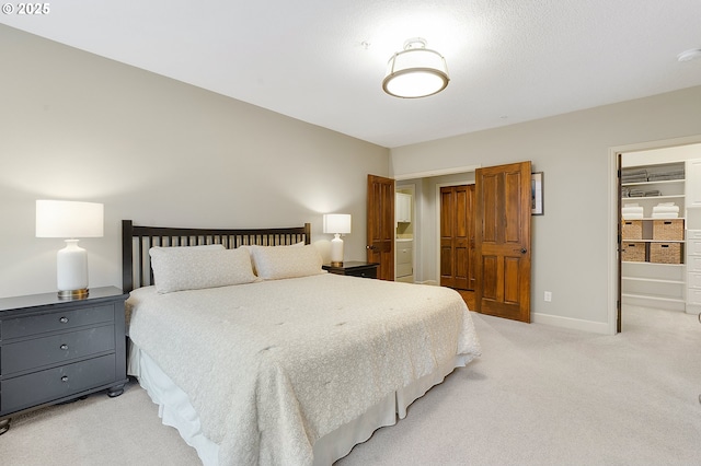 carpeted bedroom featuring ensuite bath