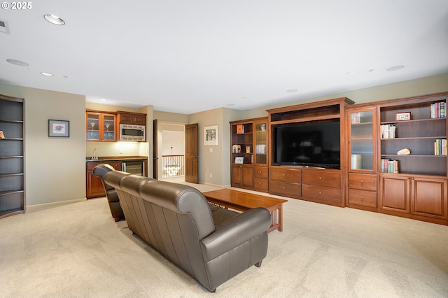 carpeted living room featuring wet bar