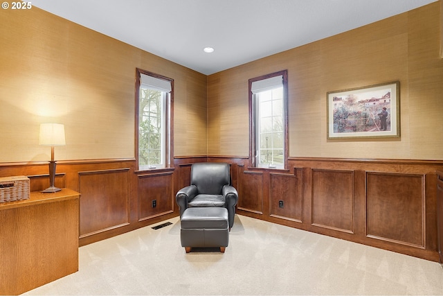 sitting room featuring light colored carpet