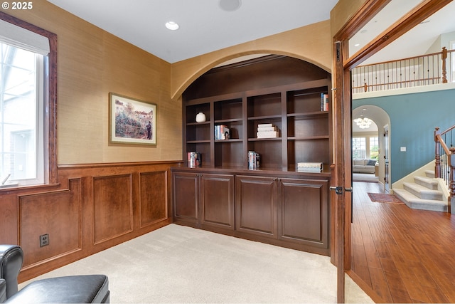 carpeted office featuring built in shelves