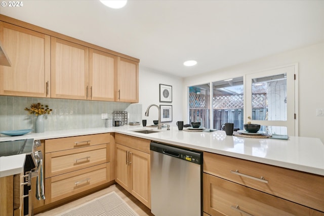 kitchen with tasteful backsplash, appliances with stainless steel finishes, sink, and light brown cabinets