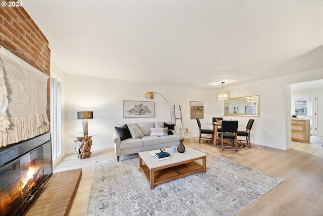 living room featuring a fireplace and light wood-type flooring