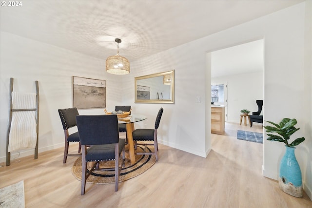 dining space with light hardwood / wood-style flooring