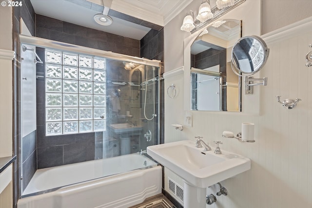 full bath with shower / bath combination with glass door, a sink, and crown molding