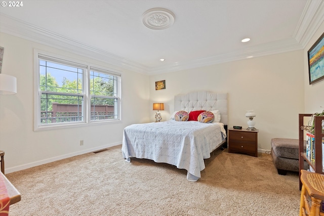 bedroom with ornamental molding, visible vents, light carpet, and baseboards