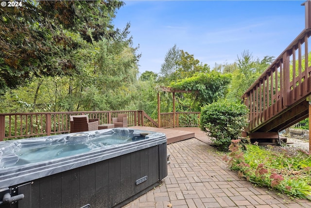 view of patio featuring a hot tub and a deck