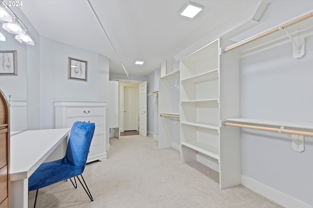 spacious closet featuring light carpet