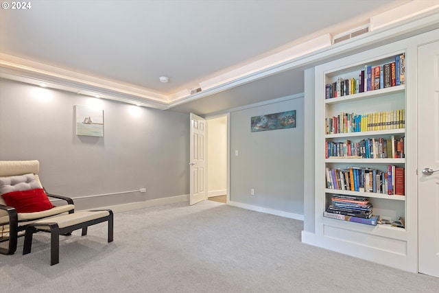 sitting room with light carpet and built in features