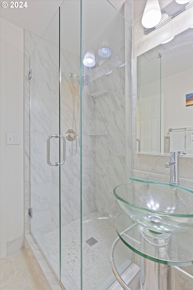 bathroom with a marble finish shower