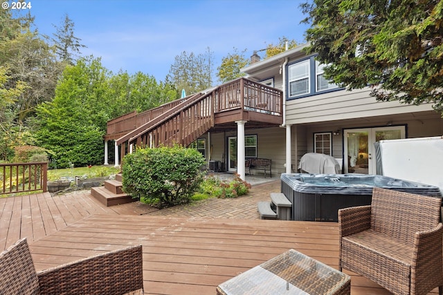 wooden terrace featuring a patio area and a hot tub