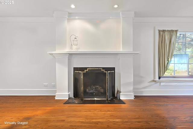 interior details with a fireplace with flush hearth, recessed lighting, baseboards, and wood finished floors