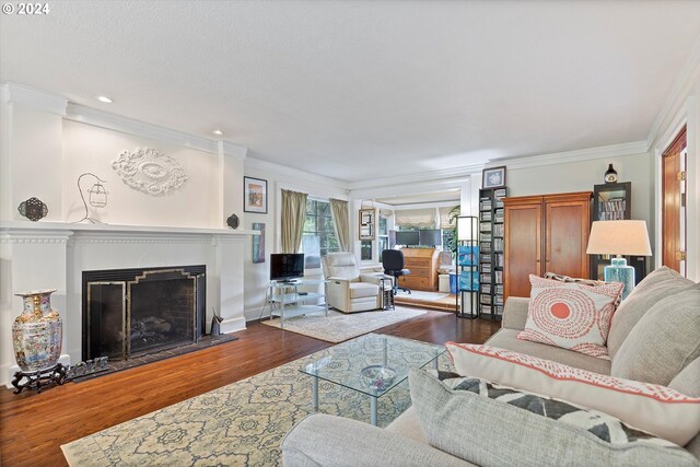 living room with dark hardwood / wood-style floors and crown molding