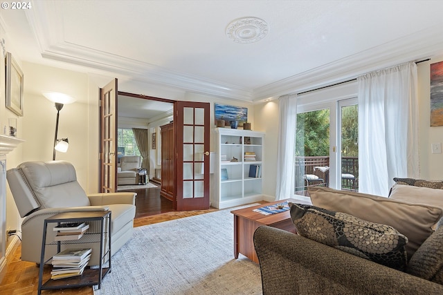 living area with light wood-style flooring, ornamental molding, and french doors