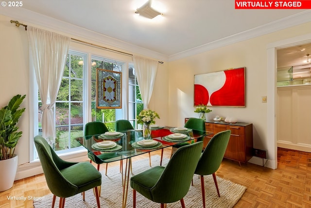 interior space with plenty of natural light, crown molding, and baseboards