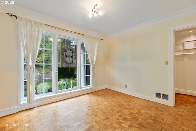 unfurnished room featuring ornamental molding, visible vents, and baseboards